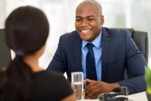 successful african american insurance broker meeting client in office